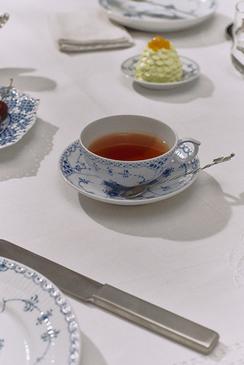 An elegant table set with Blue Fluted Half Lace and Blue Fluted Full Lace